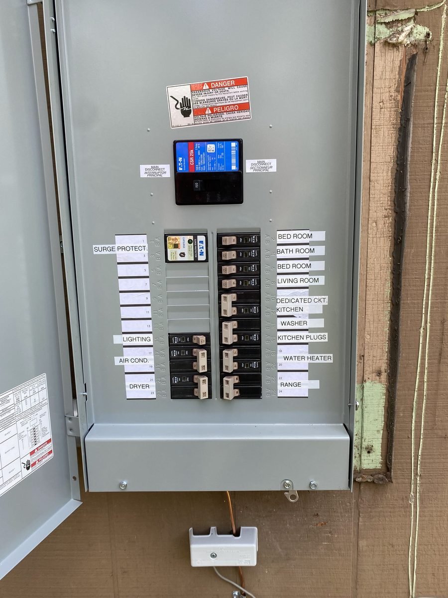Eaton whole-home surge protector wired into a labeled electrical panel by Simms Electrical Services in the Austin, TX area